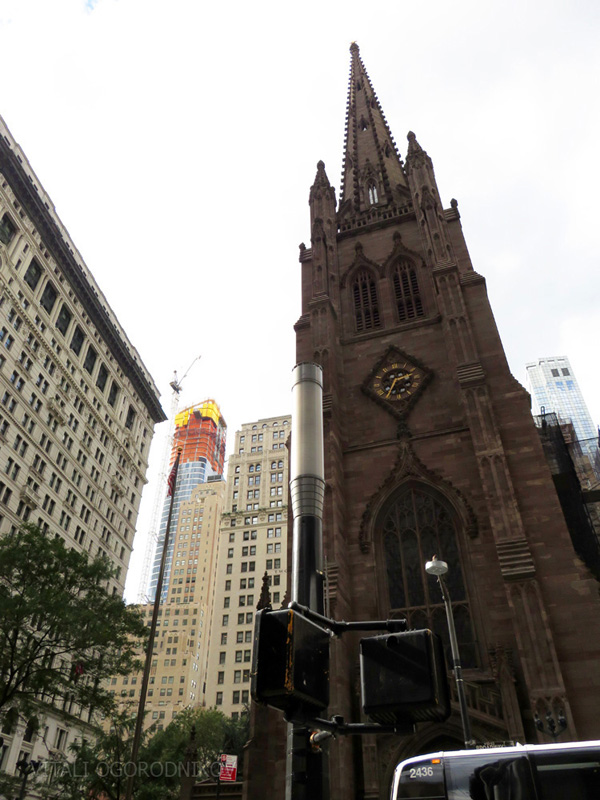 Looking west from the intersection of Wall Street and Broadway, with Trinity Church in the foreground