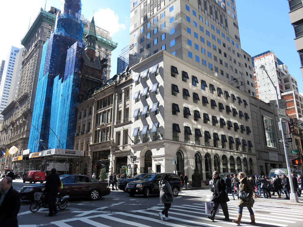 The base of 512 Fifth Avenue at the intersection of 56th Street. The tower rises behind the original buildings' facades