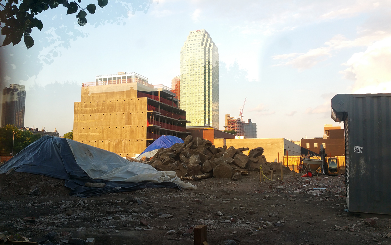 Looking east across the construction site for 11-15 46th Avenue, with the Court Square skyline rising in the background.
