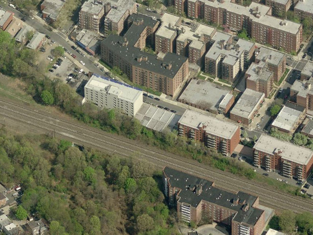 65-70 Austin Street (low-rise building abutting the train tracks, center), image from Bing Maps