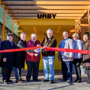 Officials from Urby and the Town of Harrison cut the ribbon on new 381-unit building at Harrison Urby. [From Left to Right] Jesus Huranga, Harrison 1st Ward Councilmember; Larry Bennett, Harrison 3rd Ward Councilmember; David Barry, Founder and CEO of Urby; James A. Fife, Mayor of Harrison; Richard Miller, CEO of The Pegasus Group; James Doran, Harrison 4th Ward Councilmember; Eleanor Villalta, Harrison 2nd Ward Councilmember; Ellen Mendoza, Harrison 2nd Ward Councilmember.