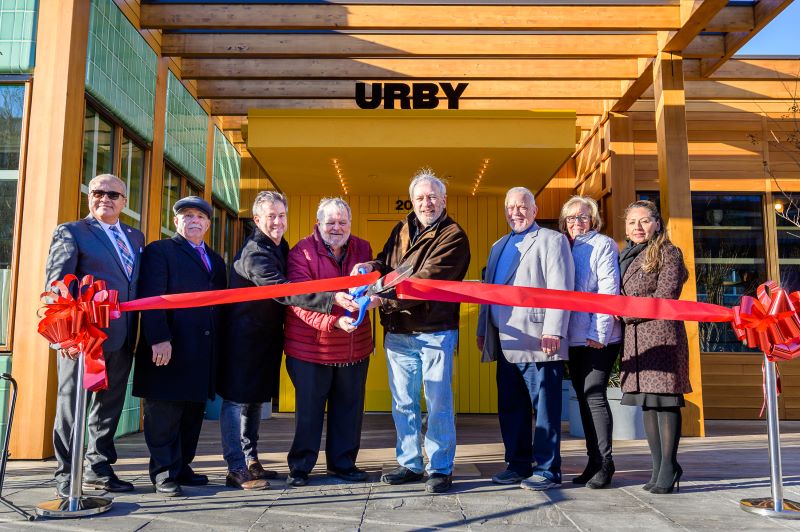 Officials from Urby and the Town of Harrison cut the ribbon on new 381-unit building at Harrison Urby. [From Left to Right] Jesus Huranga, Harrison 1st Ward Councilmember; Larry Bennett, Harrison 3rd Ward Councilmember; David Barry, Founder and CEO of Urby; James A. Fife, Mayor of Harrison; Richard Miller, CEO of The Pegasus Group; James Doran, Harrison 4th Ward Councilmember; Eleanor Villalta, Harrison 2nd Ward Councilmember; Ellen Mendoza, Harrison 2nd Ward Councilmember.