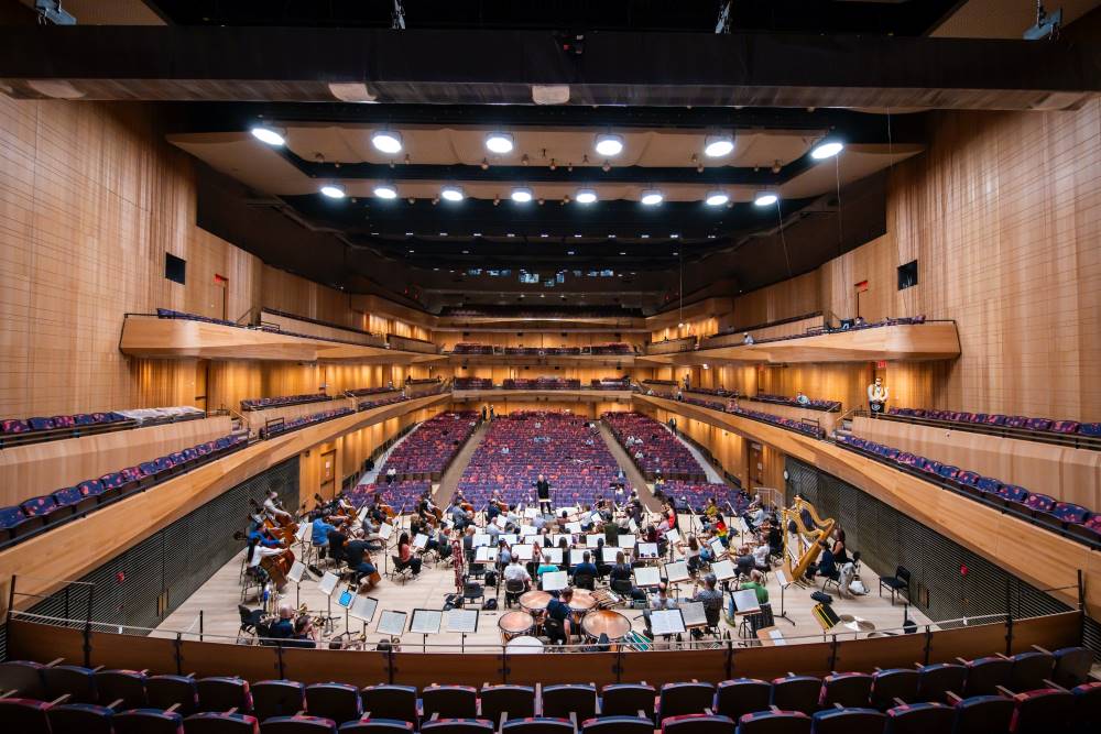The New York Philharmonic rehearsing on stage inside the Wu Tsai Theater at the new David Geffen Hall; view from behind the stage – Photo by Chris Lee, Courtesy of New York Philharmonic