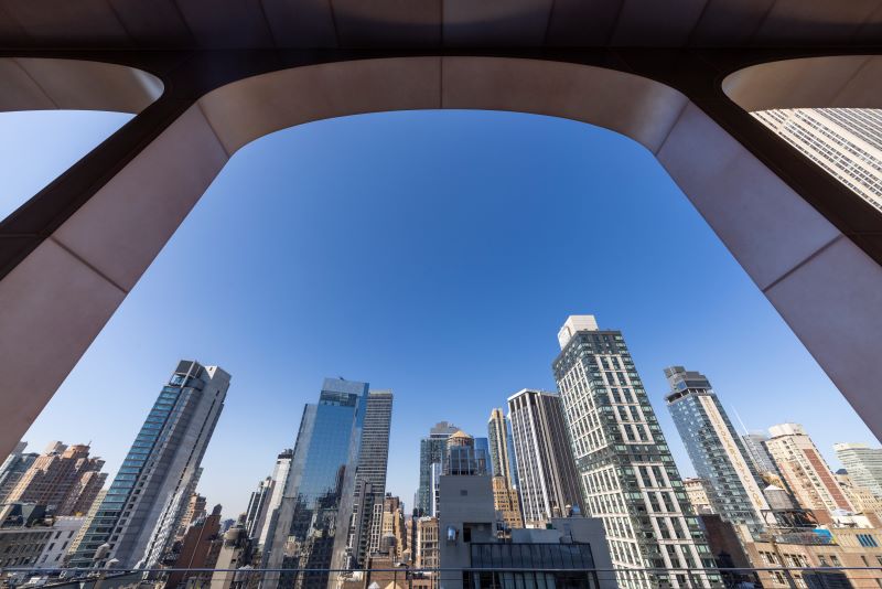 Arched canopies atop 295 Fifth Avenue penthouse frame dramatic views of the Midtown skyline