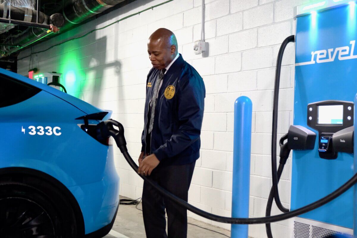 New York City Mayor Eric Adams charges an electric Rebel vehicle in the Dime Building