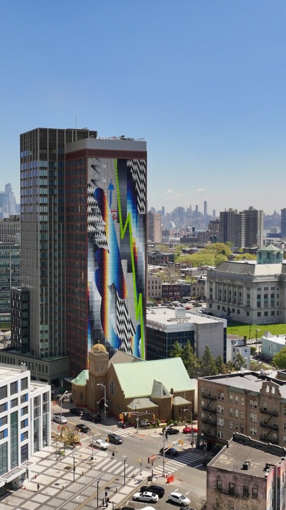 Photograph of Journal Square Urby featuring mural by Felipe Pantone, via Cahn