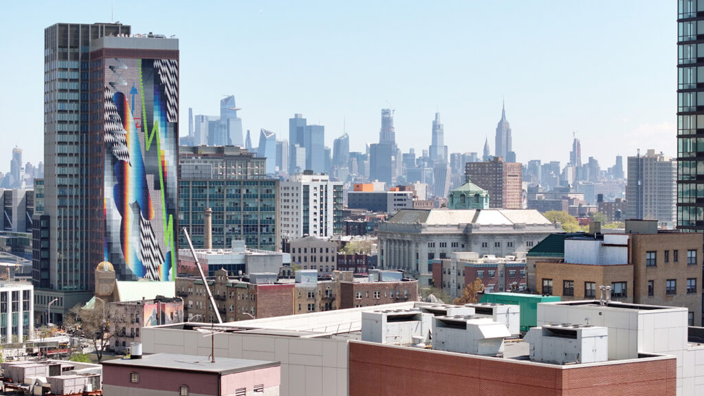 Photograph of Journal Square Urby featuring mural by Felipe Pantone, via Cahn